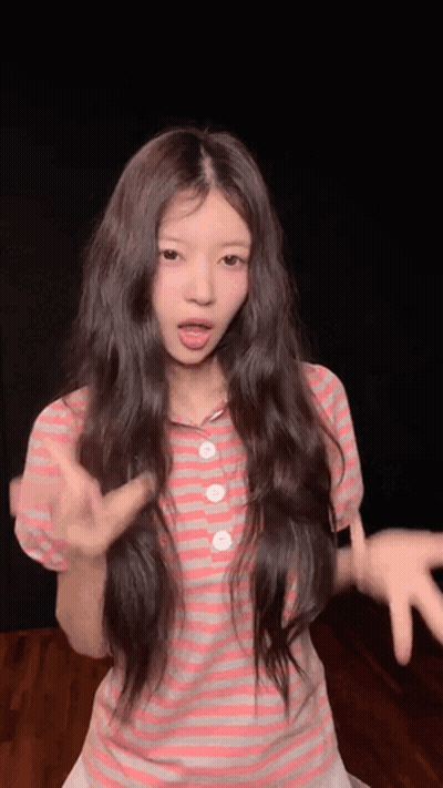 Young Girl With Long Hair Making Funny Face In Pink Striped Shirt GIF