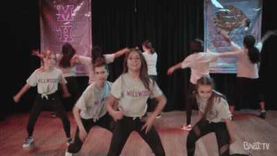 Young Girls Dancing In Front Of Millwood Banner GIF