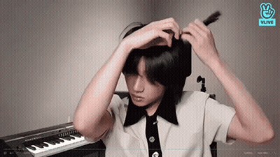 Young Man Adjusting Hair At Piano GIF