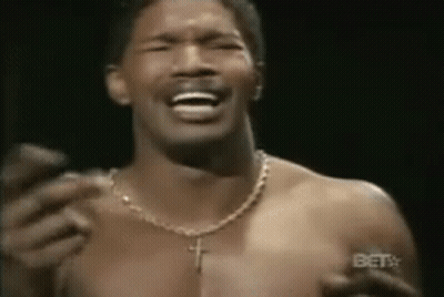 Young Man Adjusting Sunglasses In Library GIF