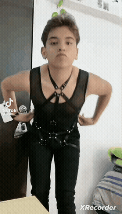 Young Man Black Vest Pants Hands on Hips