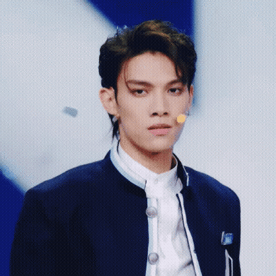 Young Man Blue Jacket Microphone Looking At Camera GIF