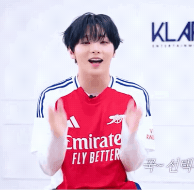 Young Man Clapping In Red Emirates Jersey GIF