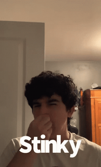 Young Man Covering Nose Saying Stinky GIF