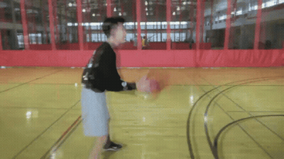 Young Man Dribbling Basketball On Court GIF