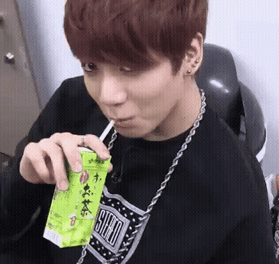 Young Man Drinking Through Straw From Box GIF