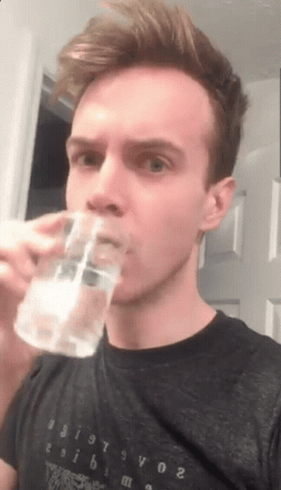 Young Man Drinking Water From Glass GIF