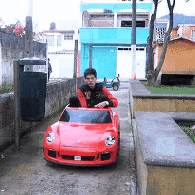Young Man Driving Red Car With SD License Plate GIF