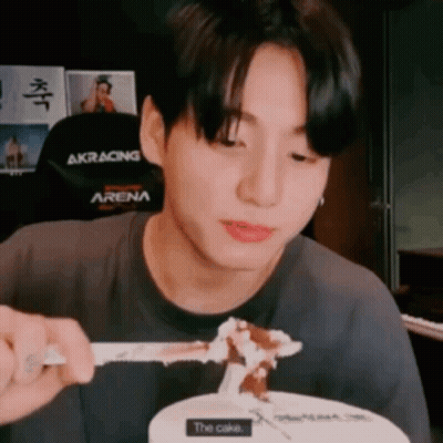 Young Man Eating Cake With Fork And Spoon GIF