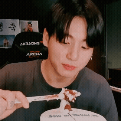Young Man Eating Cake With Knife And Fork In Black Arena Shirt GIF
