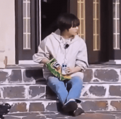 Young Man Eating Chips On Steps GIF