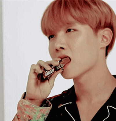Young Man Eating Snickers Bar With Tongue GIF