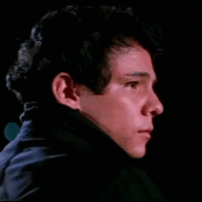 Young Man Face Close Up In Dark Room GIF