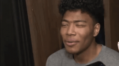 Young Man Gray Shirt Phone Talks To Reporter GIF