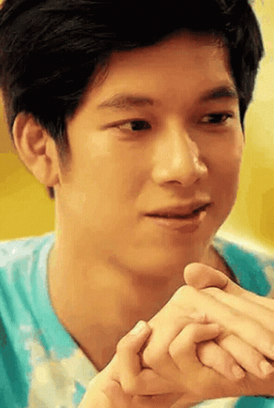 Young Man Holding Another Man's Hand Looking At Camera GIF