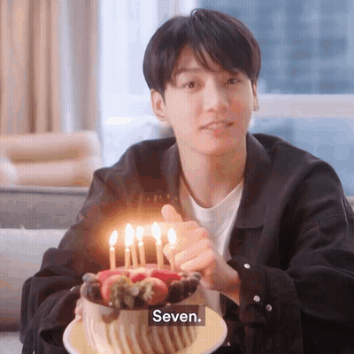 Young Man Holding Cake With Candles Thumbs Up GIF