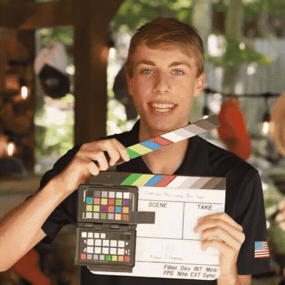 Young Man Holding Clapper Board GIF