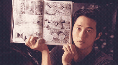 Young Man Holding Comic Book GIF