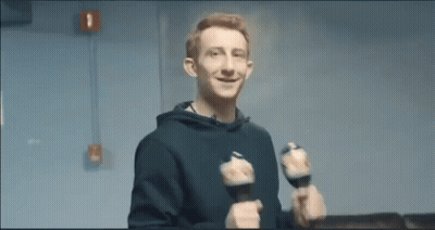 Young Man Holding Dumbbells Smiling