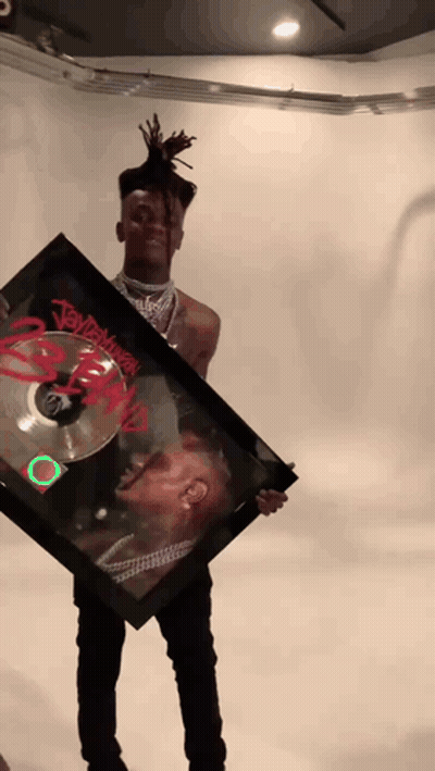 Young Man Holding Framed Picture Of Dreadlocked Man Named Jay Z GIF