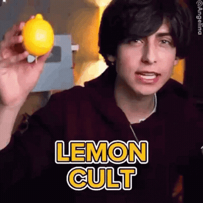 Young Man Holding Lemon With Lemon Cult Text GIF