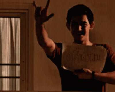 Young Man Holding Paper Making Devil Horns GIF