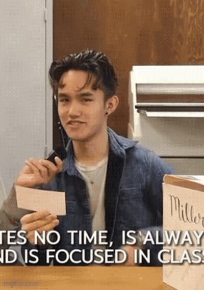 Young Man Holding Paper Saying Yes No Time Is Always And Is Focused In Class GIF