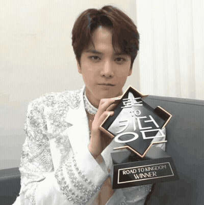 Young Man Holding Road To Kingdom Trophy GIF