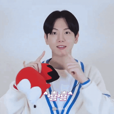 Young Man Holding Stuffed Animal With Chinese Writing GIF