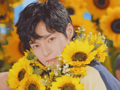 Young Man Holding Sunflowers Saying Osr GIF