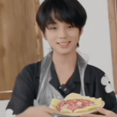 Young Man In Apron Holding Plate Of Food GIF