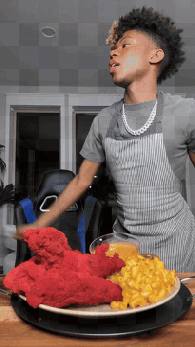 Young Man In Apron With Plate Of Food GIF