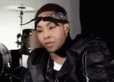 Young Man In Bandana And Black Jacket At Drum Set GIF