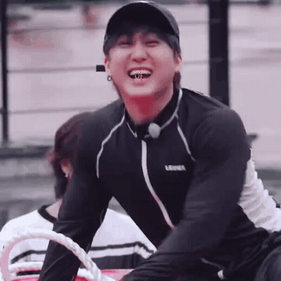 Young Man In Baseball Cap And Black Shirt Sitting On Boat GIF
