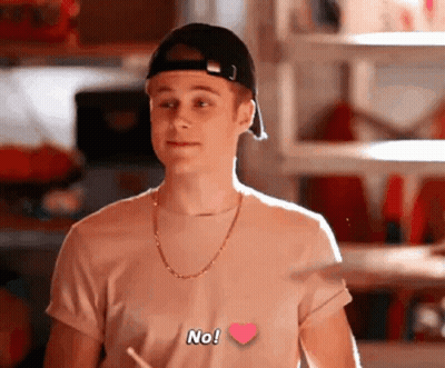 Young Man In Baseball Cap And Heart T-Shirt GIF