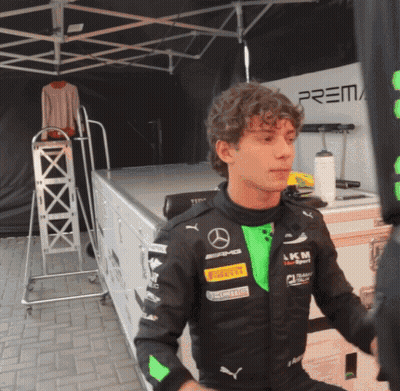 Young Man In Black And Green Mercedes Racing Suit GIF