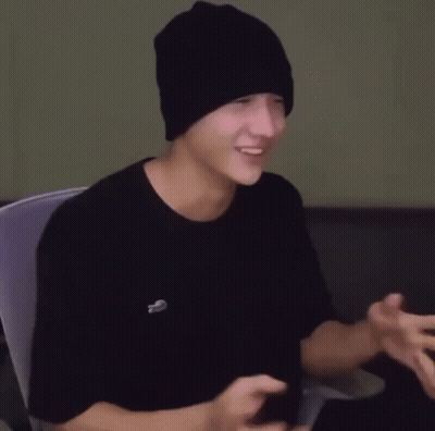 Young Man In Black Beanie And T-Shirt Sitting GIF