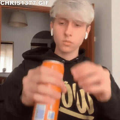 Young Man In Black Hoodie Opening Orange Soda Can GIF