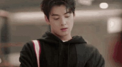 Young Man In Black Hoodie Standing In Room GIF