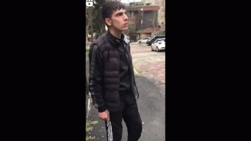 Young Man In Black Jacket Arms Outstretched GIF