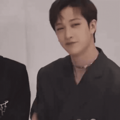 Young Man In Black Jacket Holding Hands To Chest GIF