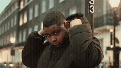 Young Man In Black Jacket In Front Of Sign Saying 30 GIF