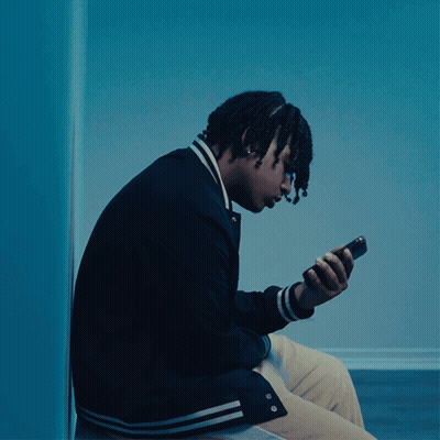 Young Man In Black Jacket Looking At Phone GIF