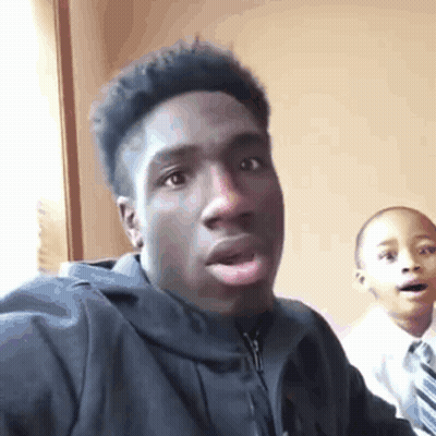 Young Man In Black Jacket Taking Selfie GIF