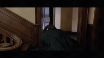 Young Man In Black Jacket Walking Down Wooden Stairs GIF