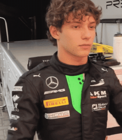 Young Man In Black Jacket With Mercedes And Irelli Logos GIF