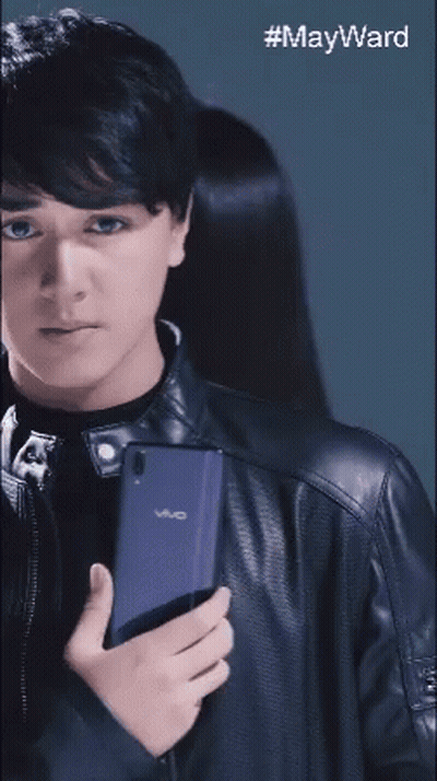 Young Man In Black Leather Jacket Holding Vivo Phone GIF