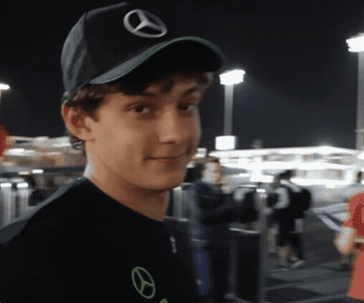 Young Man In Black Mercedes Hat Looking At Camera GIF