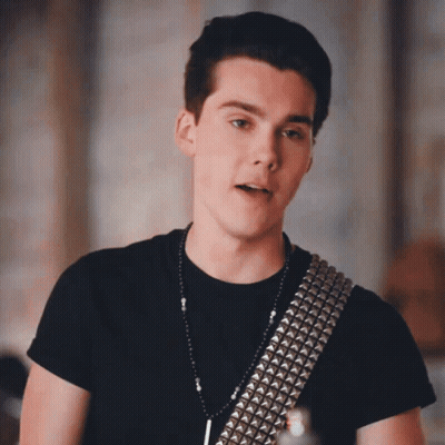 Young Man In Black Shirt And Silver Studded Belt GIF