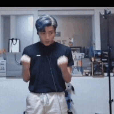 Young Man In Black Shirt And White Shorts Raising Hands GIF